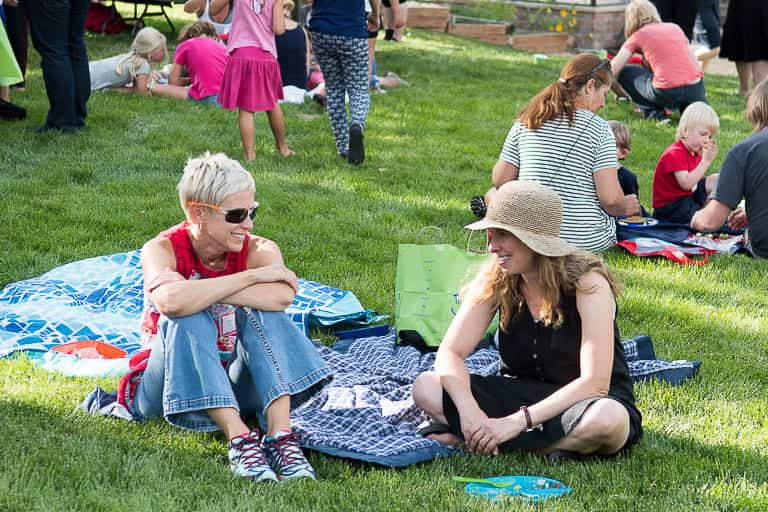 parents sitting on a blanket at school picnic