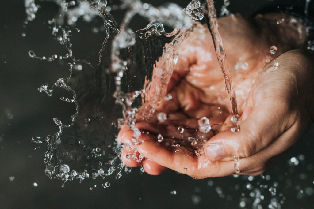 a hand receiving a splash of water illustrates the World Affairs Challenge