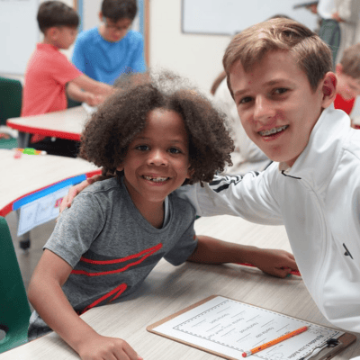 two boys in classroom smiling